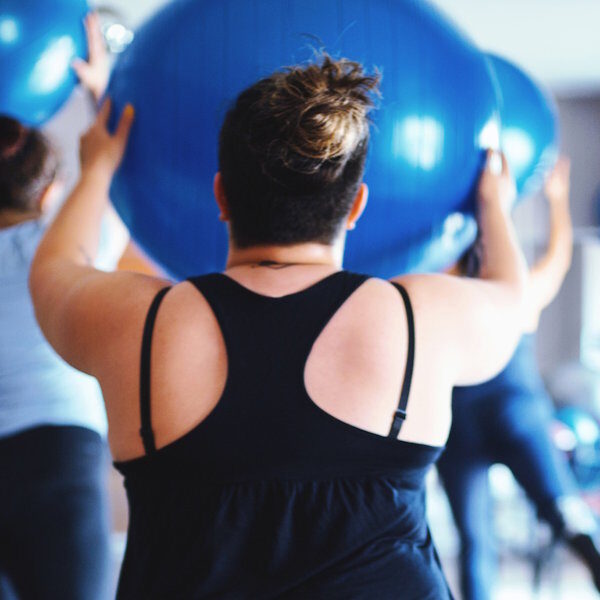 Overweight women working out together in the gym