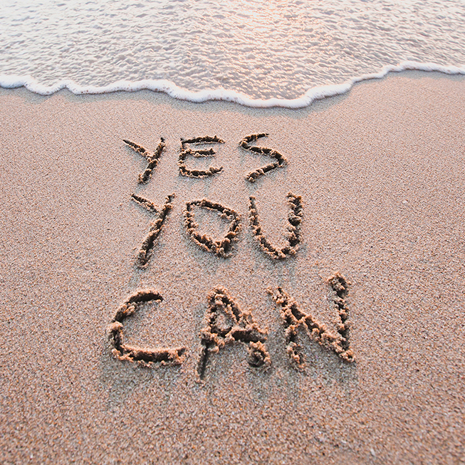 yes you can, motivational inspirational message concept written on the sand of beach